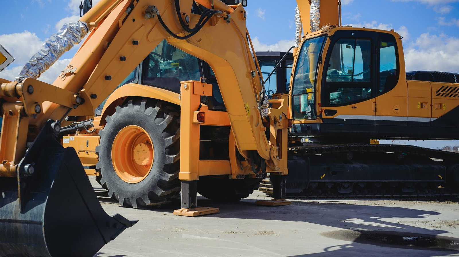 road-building machinery, tractors yellow excavators in the open air in working position